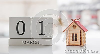 March calendar and toy home. Day 1 of month. Ð¡ard message for print or remember Stock Photo